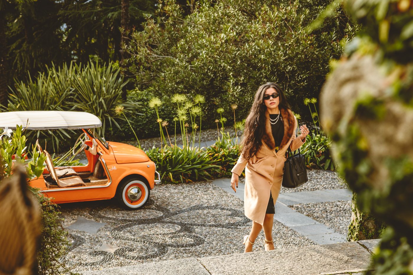 Simone in a camel coat with a fur collar